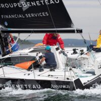 Crew navigating Beneteau Figaro 3 sailboat