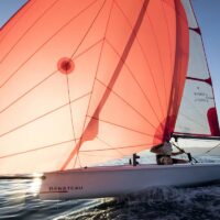 Beneteau First 14 sailboat with open sail on the water