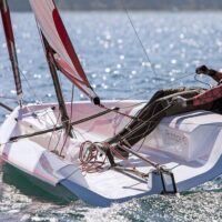 one person sailing a Beneteau First 14 SE sailboat