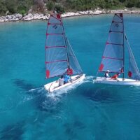 two Beneteau First 14 SE sailboats in blue lagoon