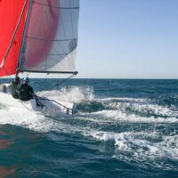 two people sailing a Beneteau First 18 SE sailboat