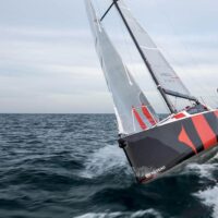 Beneteau First 24 sailboat cutting through water while turning