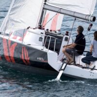 two people sailing a Beneteau First 24 sailboat