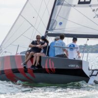group of 5 people on a Beneteau First 24 sailboat