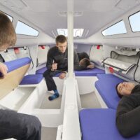 man showing amount of room inside a Beneteau First 24 SE