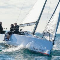 three people sailing on a Beneteau First 24 SE