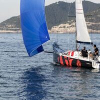 Beneteau First 27 with blue and white sails