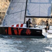 Beneteau First 27 sailing close to shore