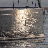 Beneteau First Yacht 53 hull with sunrise reflecting off side