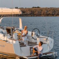 couple on stern of a Beneteau Oceanis 38.1 during sunset
