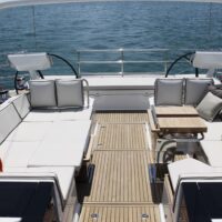 Beneteau Oceanis Yacht 62 duel helm with one table up in seating area