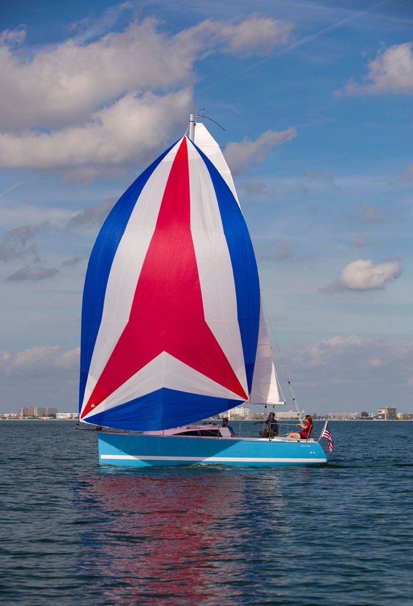 Catalina Yachts 275 Sport with a fully open red, white, and blue sail