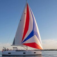 Catalina Yachts 545 with full red, white, and blue sails