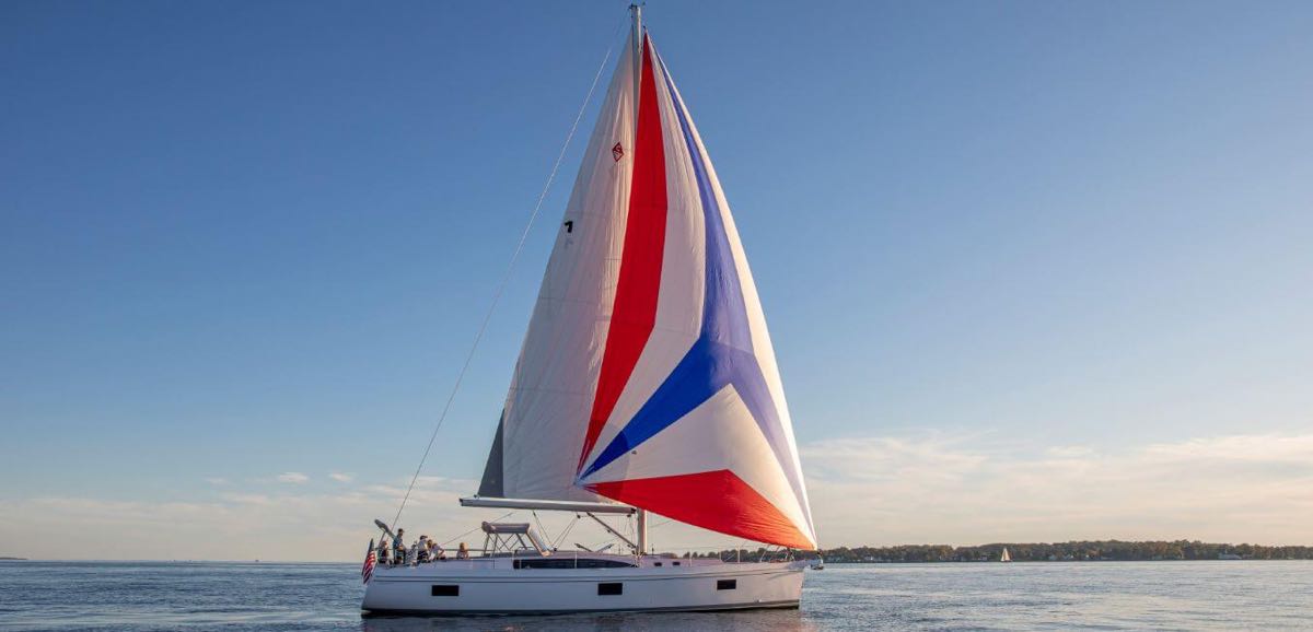Catalina Yachts 545 with full red, white, and blue sails