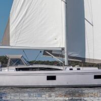 Catalina Yachts 545 sideview with white sails in water