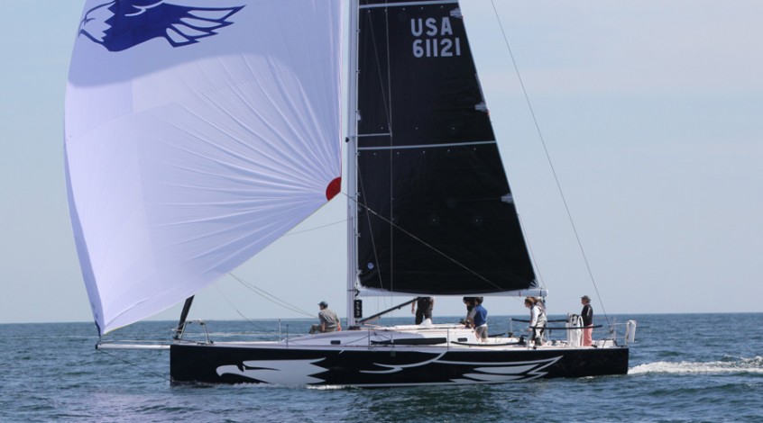J Boats J/121 with small black sail and large white sail in open waters