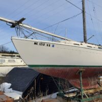 Hughes 26 - "Shamrock" sailboat on saddle in outdoor storage yard