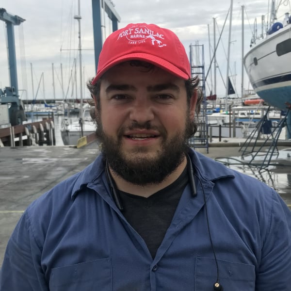 Will Rankin, a young man with a beard wearing a blue shirt and red hat