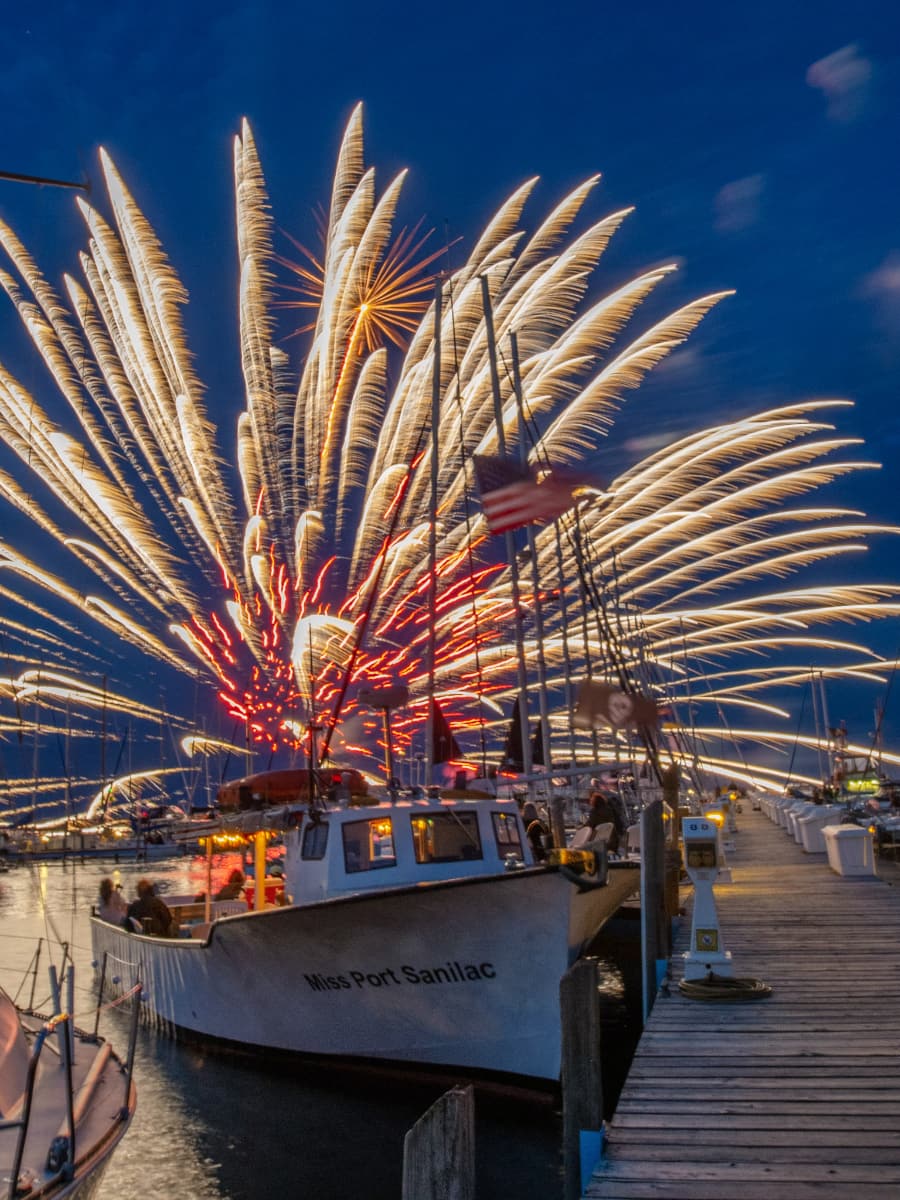 Fireworks in the night sky of the Miss Port Sanilac Charter Boat