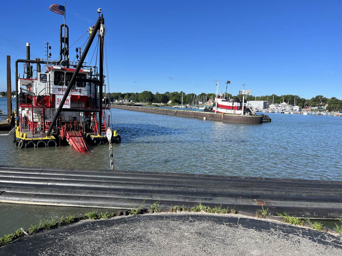 Buxton II Dredger and its tugboat in Port Sanilac Harbor