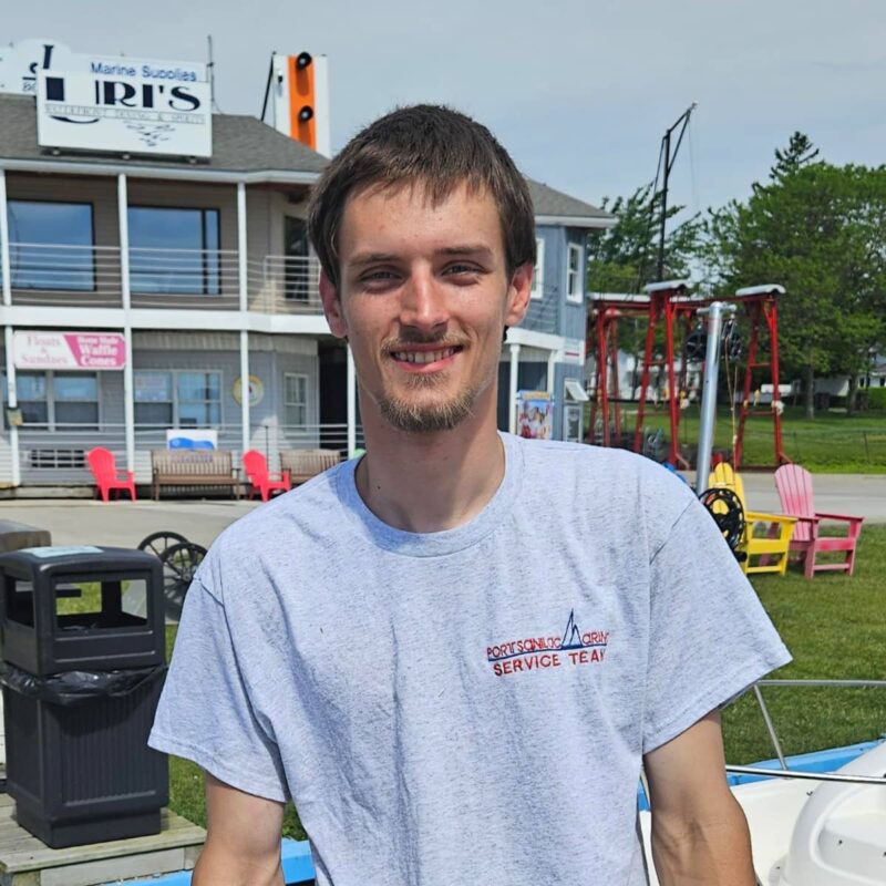 service technician Brandon Travis, young smiling man with gray service team t-shirt