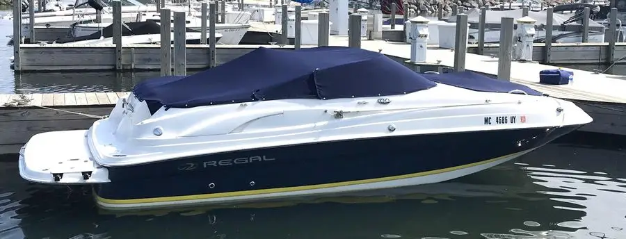 2005 Regal 2120 Destiny powerboat in marina with cover on
