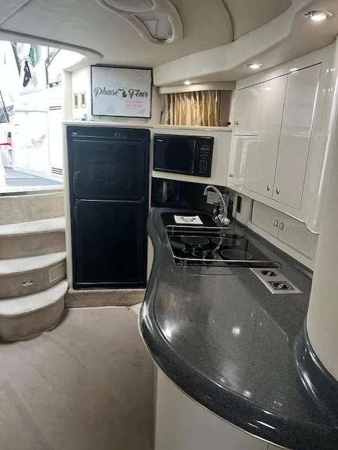 1997 Sea Ray 400 Sundancer interior galley fridge, stove, countertop