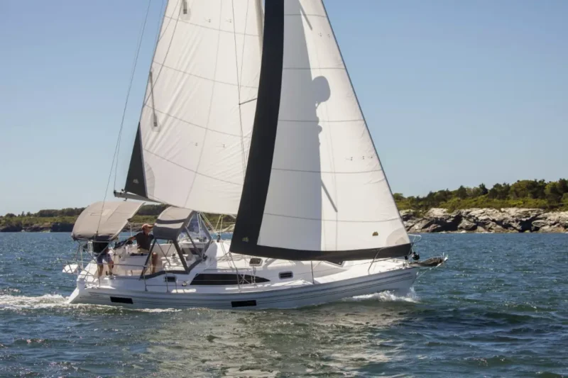 Catalina 316 sailboat with full sails tilting in water