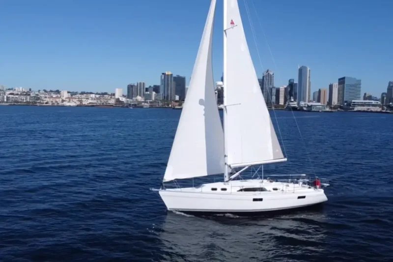 Catalina 386 sailboat on water near large city