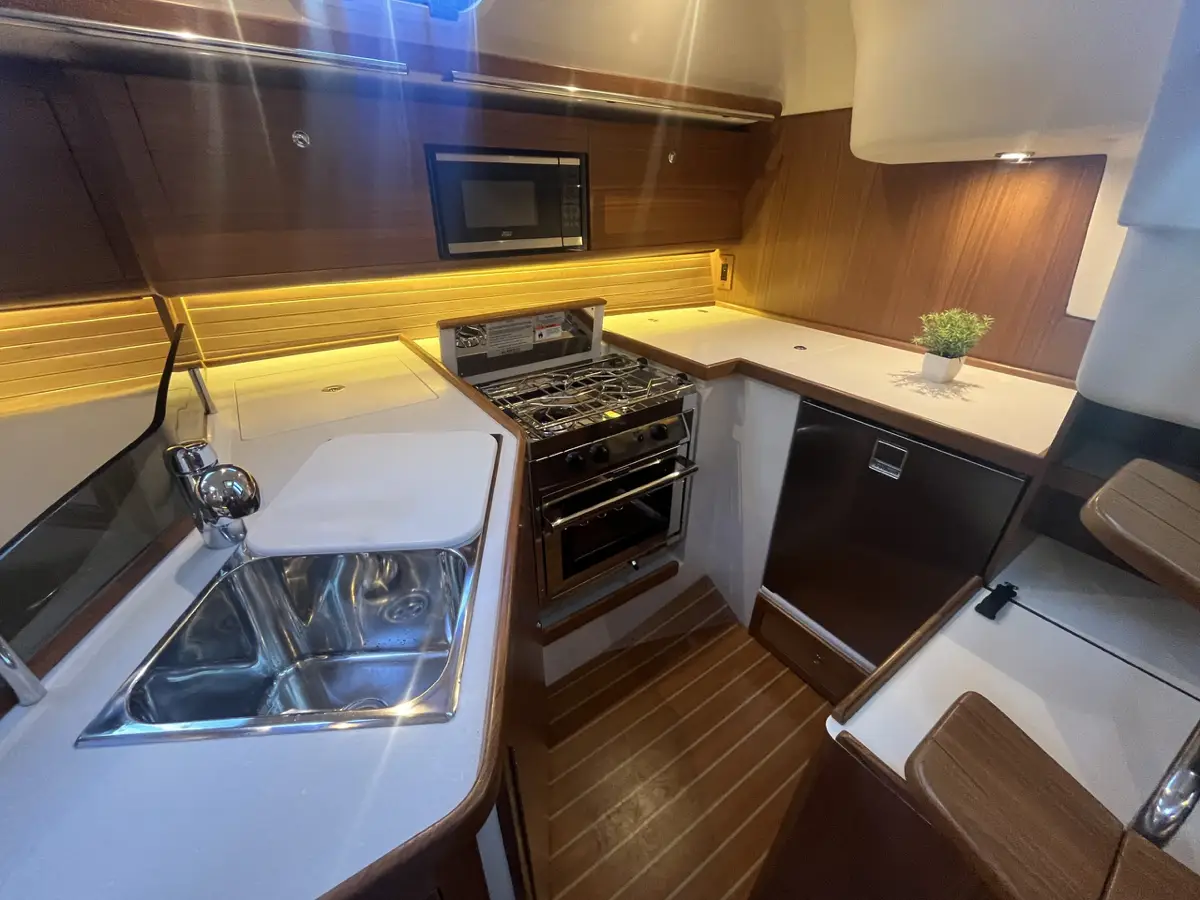 Catalina 386 sailboat interior galley with sink, stove, and dishwasher