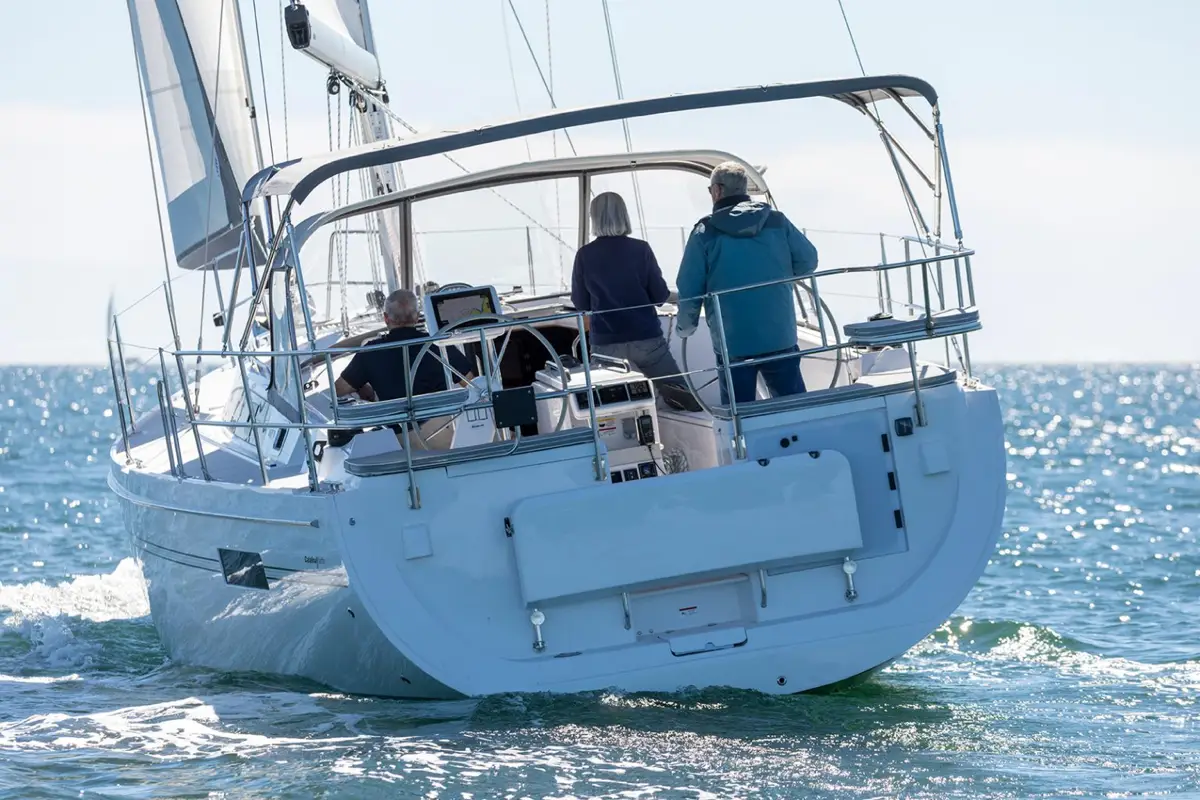Catalina 426 sailboat with crew on water from behind