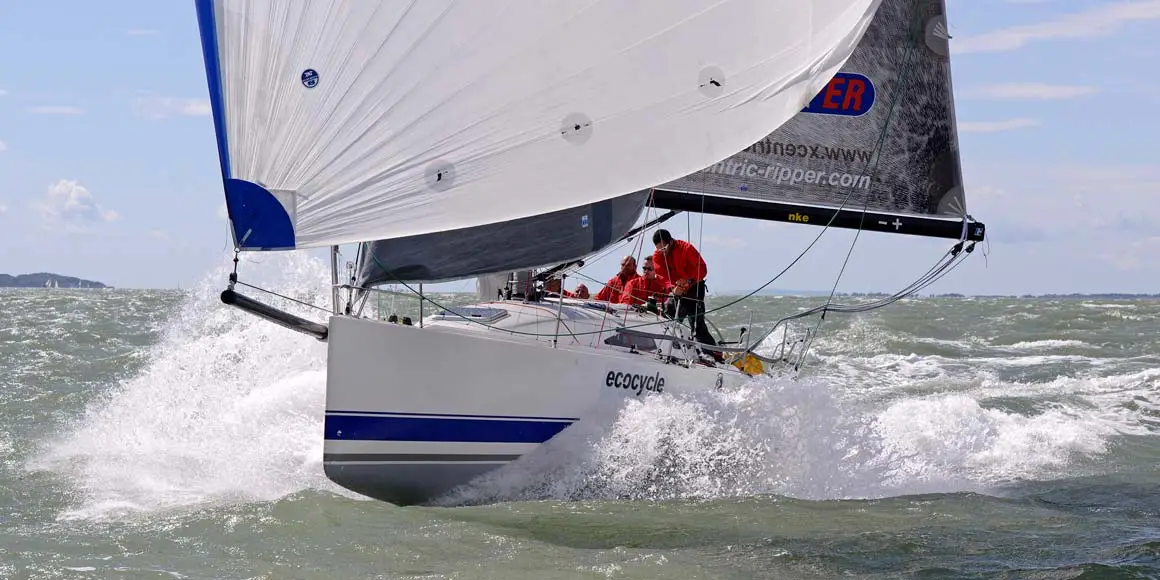 Crew in rough water sailing a J-Boat J/111 sailboat.