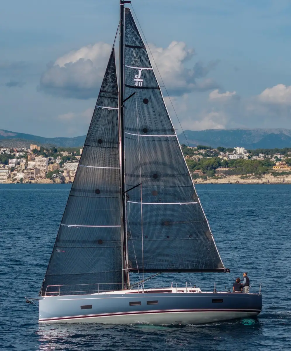 Full view of a J-Boat J-40 sailboat with dark sails.