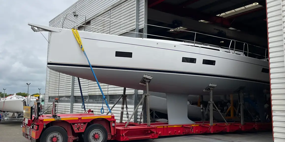 J-Boat J-40 sailboat on a trailer coming out of storage warehouse.