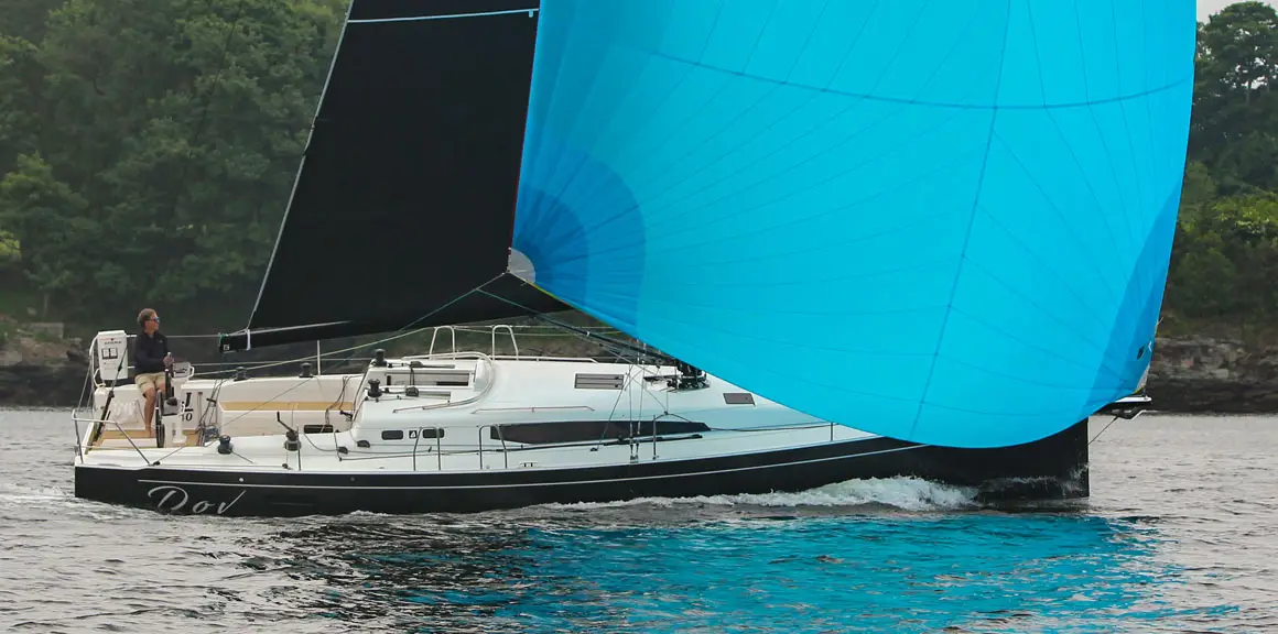Black and bright blue sails of a J-Boat J-40 sailboat.