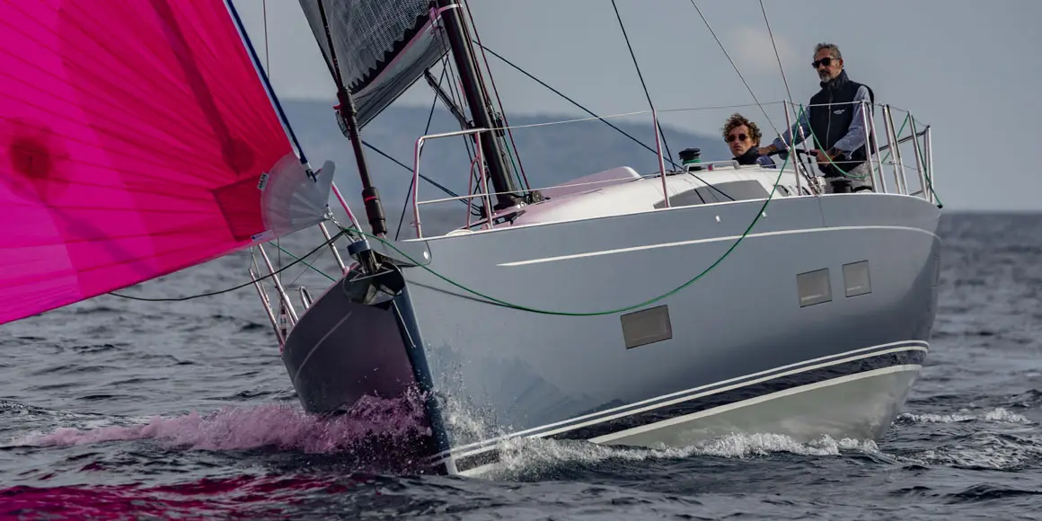 Two sailors on a J-Boat J-40 sailboat.
