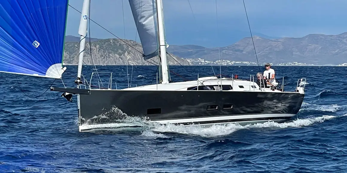 Two people sailing a J-Boat J/45 sailboat.