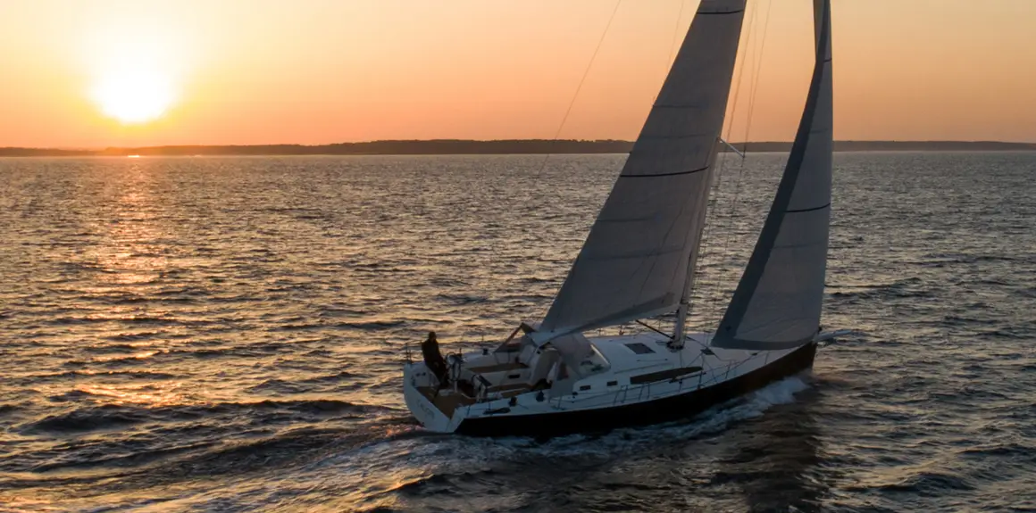 J-Boat J/45 sailboat sailing at sunset.