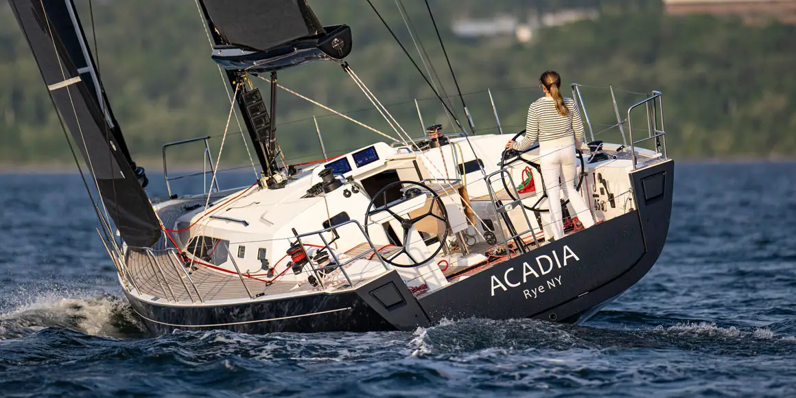 Acadia J-Boat J/45 sailboat being steered by a woman.