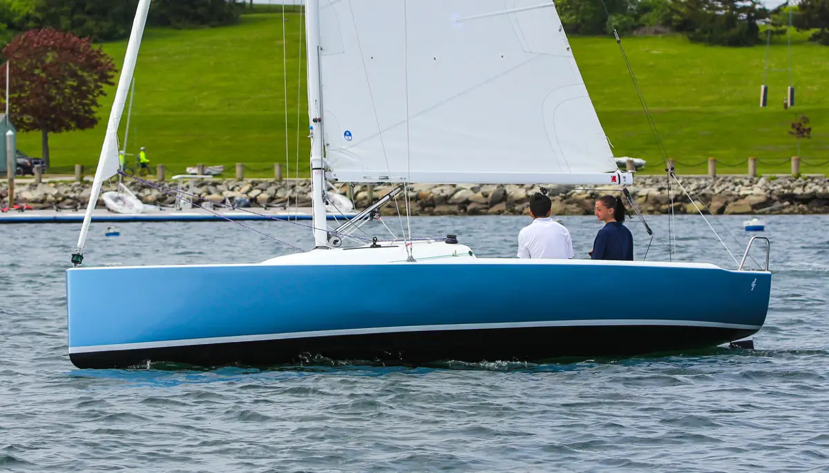 Two young people sitting in a J-Boat J-7 sailboat