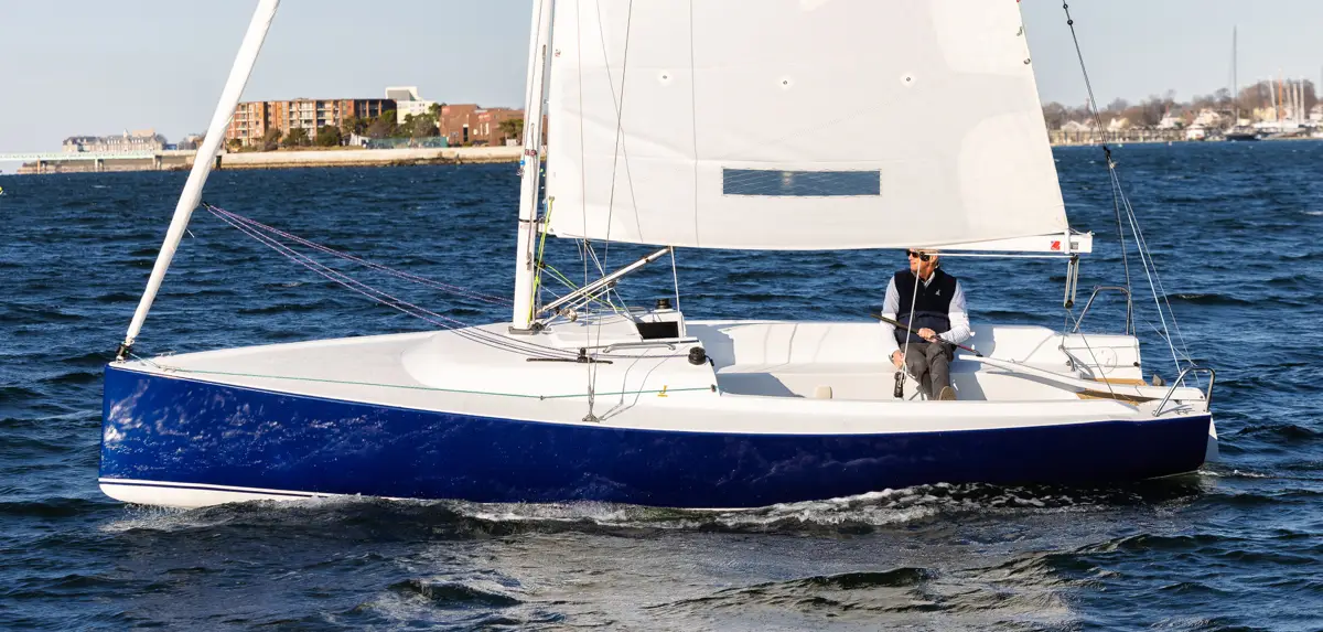 Older man sailing a J-Boat J-7 sailboat.