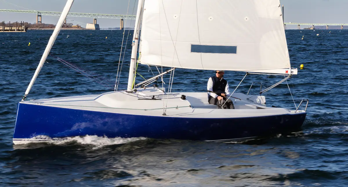 Older man sailing a J-Boat J-7 sailboat.