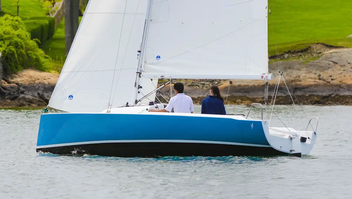 Two young people sailing a J-Boat J-7 sailboat.