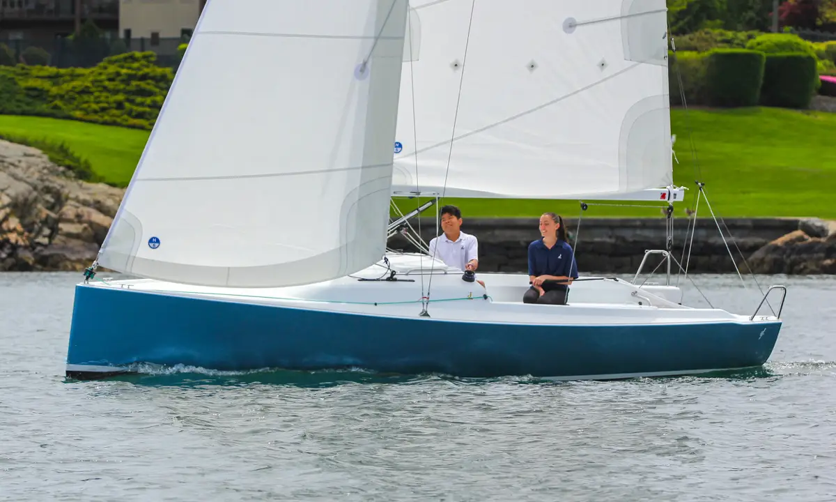 Two young people sailing a J-Boat J-7 sailboat.
