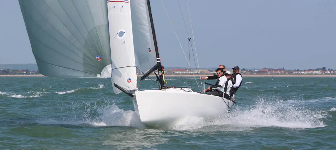 Racing crew sailing a J-Boat J70 sailboat.