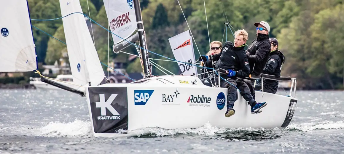 Racing crew sailing a J-Boat J70 sailboat.