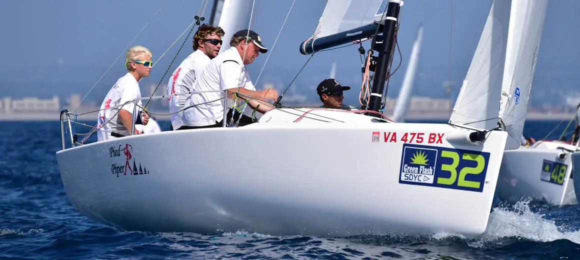 Racing crew sailing a J-Boat J70 sailboat.