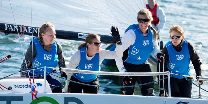 Racing crew sailing a J-Boat J70 sailboat.