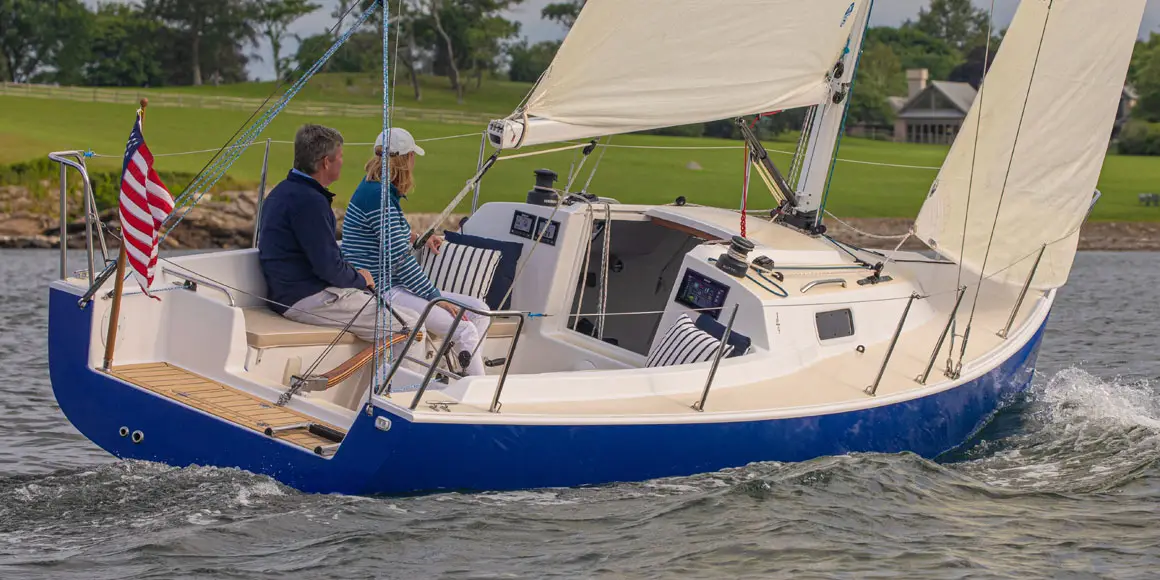 Two people sailing a J-Boat J/9 sailboat.