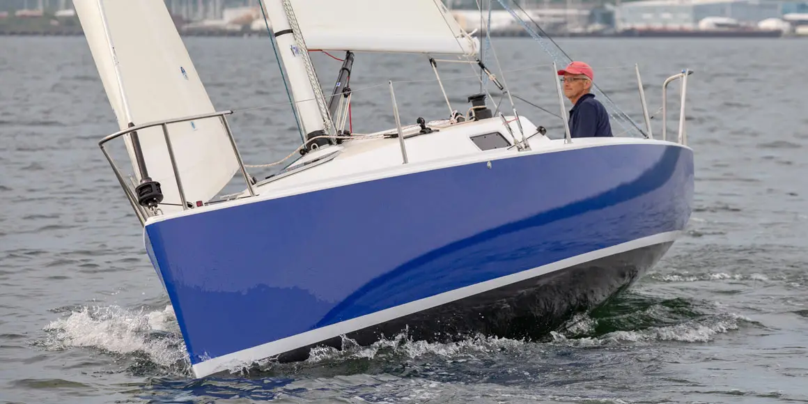 Older solo sailor on a J-Boat J/9 sailboat.